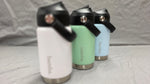 Load image into Gallery viewer, Three insulated bamba kids drink bottles in white, green, and blue on a gray surface.
