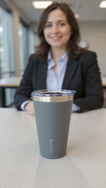 Load image into Gallery viewer, Woman in a professional setting with a bamba coffee tumbler in the foreground
