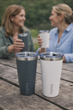 Load image into Gallery viewer, Two women sitting outdoors with bamba insulated coffee tumblers on a wooden table.

